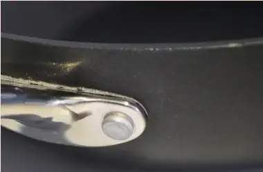 Fine scratches on the pan rim next to the handle mount